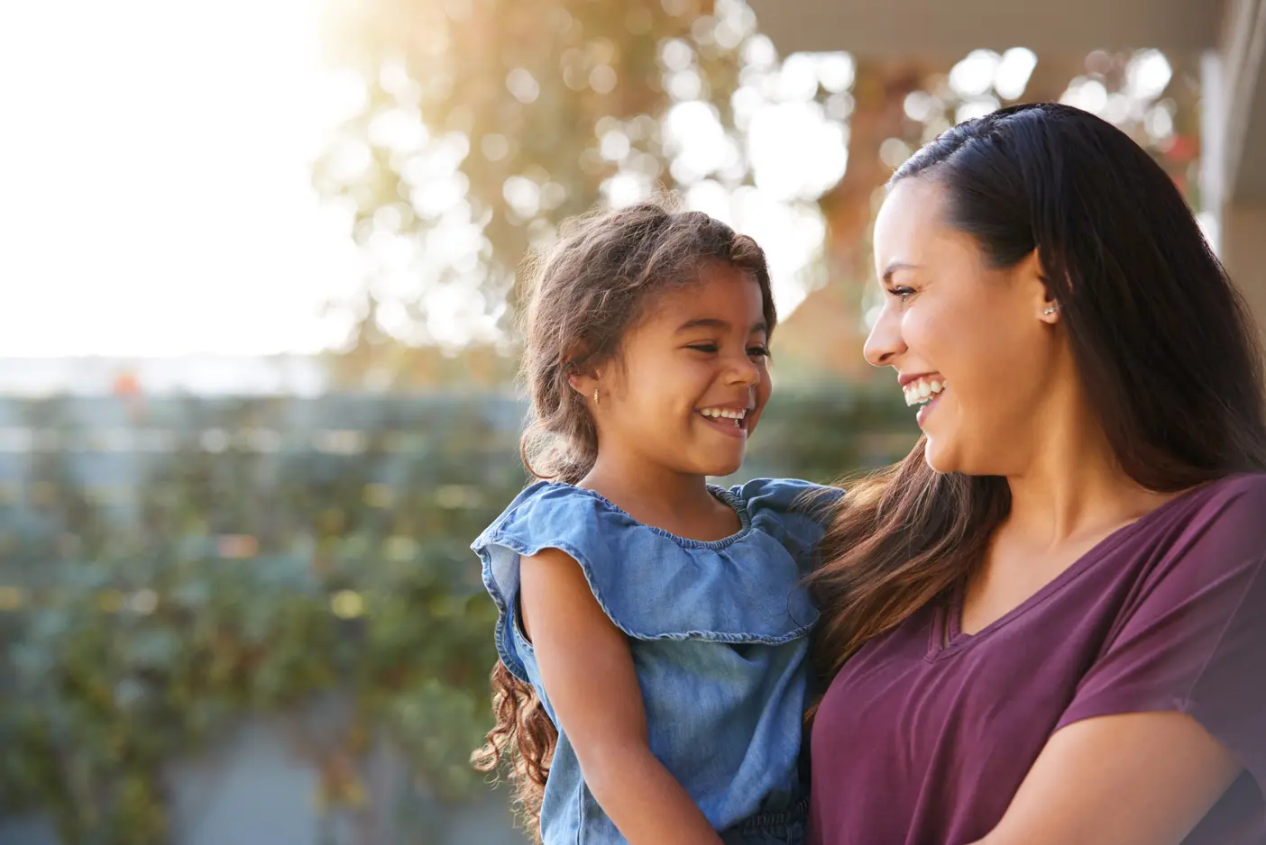 A family care giver that provides continuity of care is holding her young daughter.