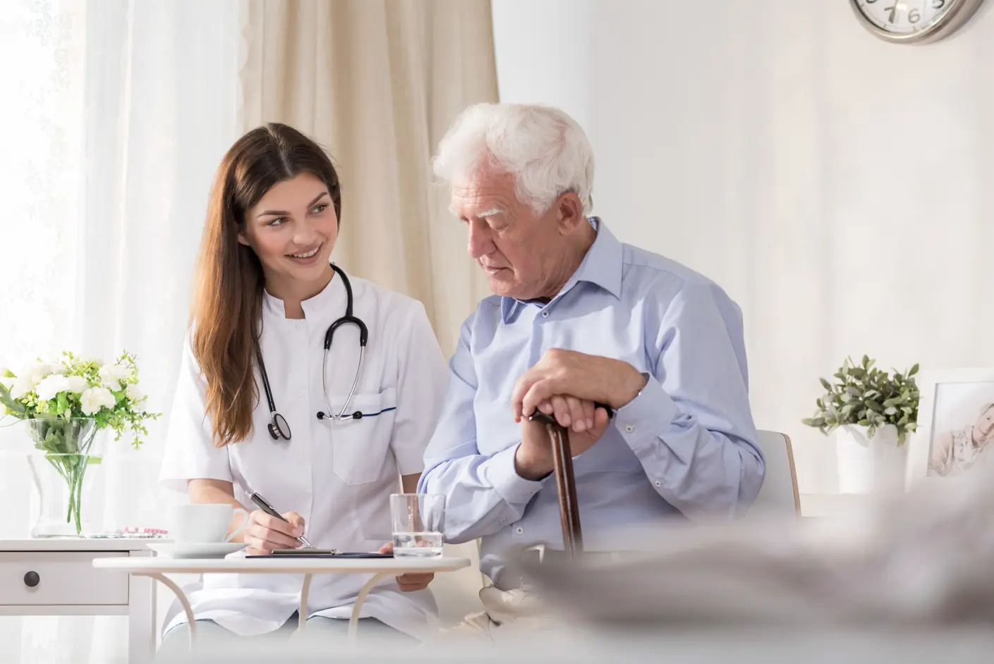 A male patient and female clinician reviewing paperwork.