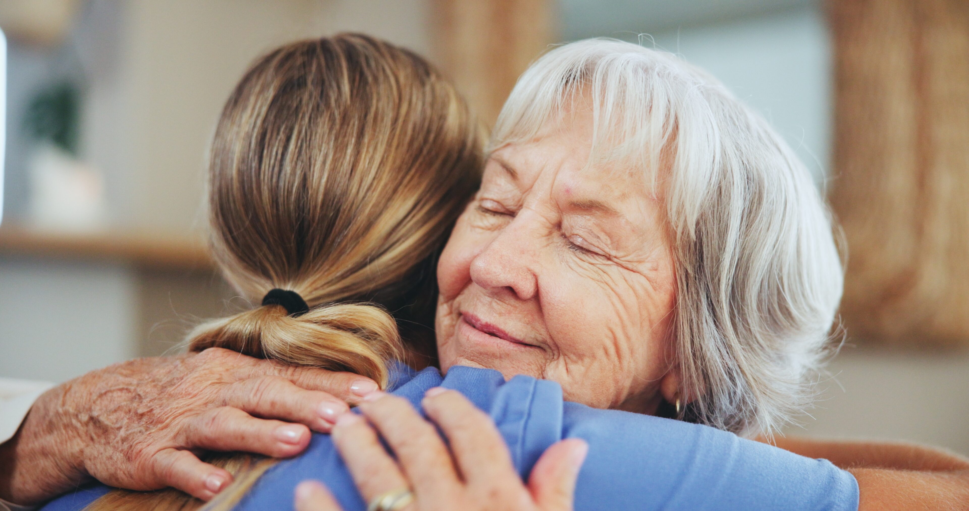 healthcare professional and patient hugging, showing where hands-on care outperforms care coordination software